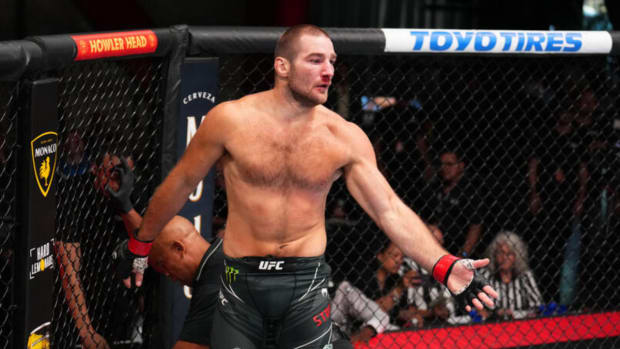 Sean Strickland begins to celebrate after a UFC victory.